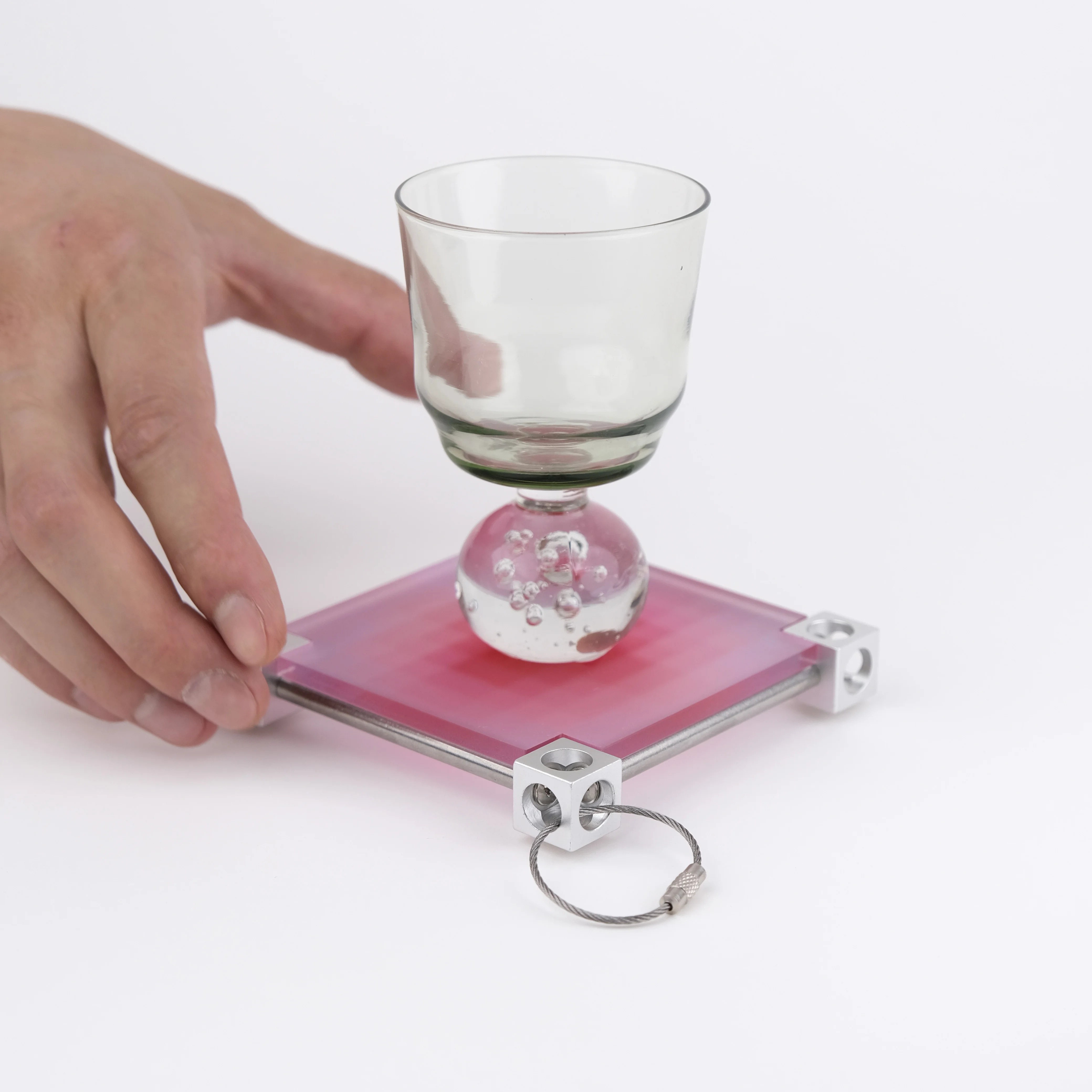 A pink A-01 Panel Tray used beneath a glass