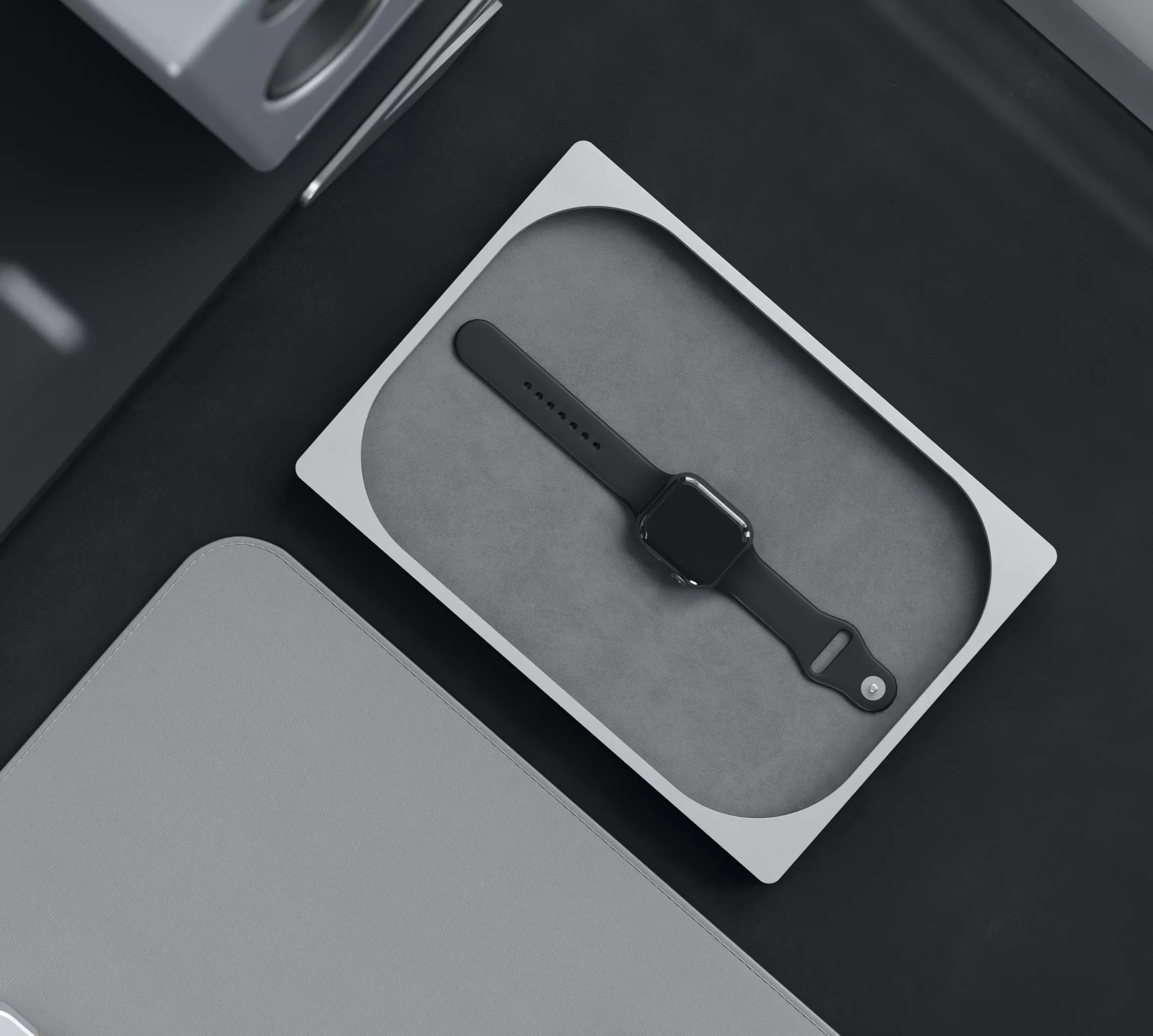A silver A-03 Tray holding a black watch